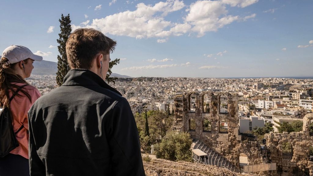 Male and female student look out over Rome, Italy.